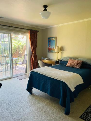 a bedroom with a bed and a sliding glass door at Super Comfortable in San Carlos