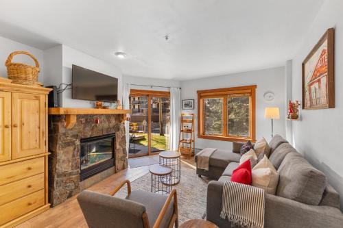 a living room with a couch and a fireplace at Red Hawk Lodge 2213 in Keystone