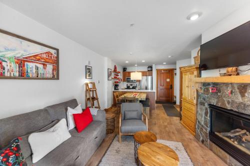 a living room with a couch and a fireplace at Red Hawk Lodge 2213 in Keystone
