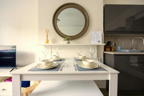 a white table with dishes on it in a kitchen at Spacious 2 Bed & 1 Bath - Close to Beach & City Centre in Brighton & Hove