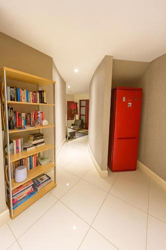 a room with a red refrigerator and a book shelf at Modern 4 Bedroom House Ring of Kerry -Killarney in Killarney