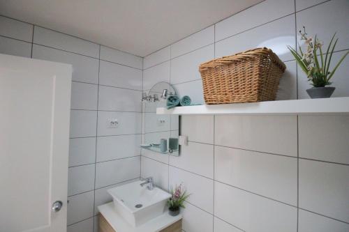 a white bathroom with a sink and a toilet at Sonja Apartman in Mogán