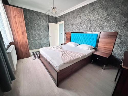 a bedroom with a large bed with a blue headboard at 216 Blue Life in Istanbul