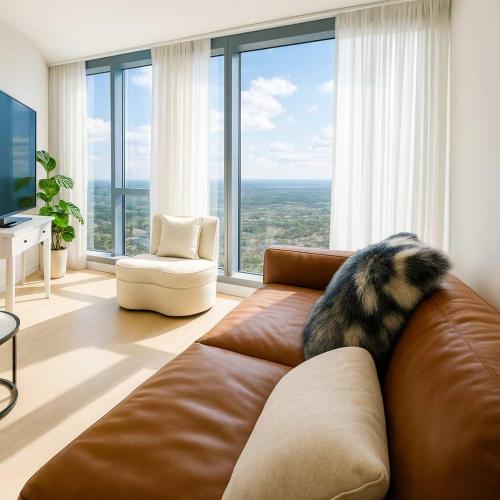 a dog laying on a couch in a living room at Skyline Grandeur Executive residence by Ritz in Melbourne
