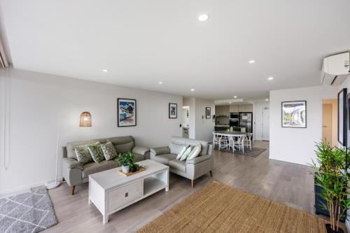 a living room with a couch and a table at Luxury Spacious 3 Bedroom Apartment - Gold Coast in Gold Coast