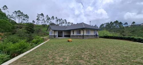 a house with a large yard in front of it at LilyRose Bungalow at Willows, Upcot, Sri Lanka 