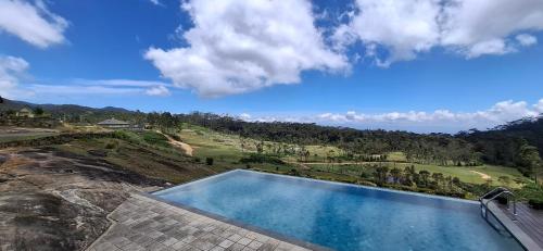 a swimming pool with a view of a mountain at LilyRose Bungalow at Willows, Upcot, Sri Lanka 