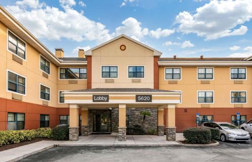 a building with a car parked in front of it at Extended Stay America Suites - Orlando - Orlando Theme Parks - Major Blvd in Orlando