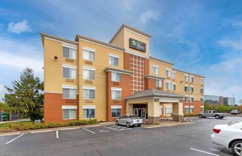 a hotel building with a car parked in a parking lot at Extended Stay America Suites - St Louis - Westport - Central in Maryland Heights