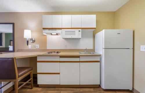 a kitchen with white cabinets and a white refrigerator at Extended Stay America Suites - Austin - Downtown - Town Lake in Austin