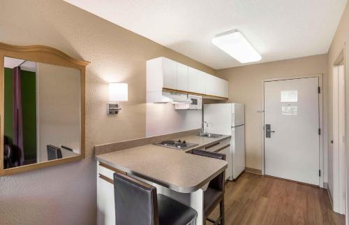 a small kitchen with a counter and a refrigerator at Studio 6 Extended Stay Milwaukee Brookfield WI in Brookfield