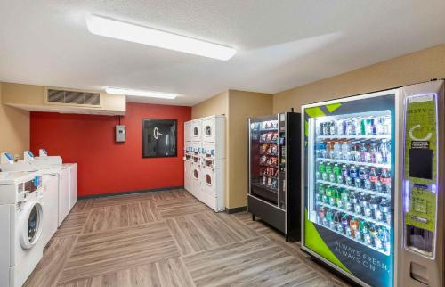 a laundry room with two refrigerators and washing machines at Studio 6 Extended Stay Milwaukee Brookfield WI in Brookfield