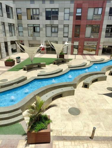 a building with a swimming pool in a courtyard at Adress cozy apartement in Sheikh Zayed