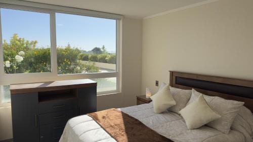 Voodi või voodid majutusasutuse Oceana Suites en Concepción toas