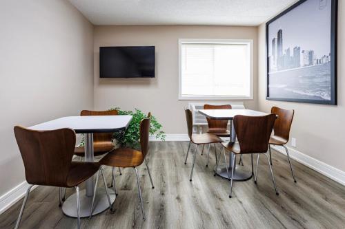 a meeting room with a table and chairs at Super 8 by Wyndham Rockford South in Rockford