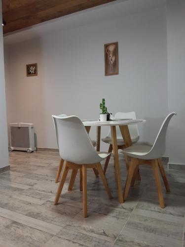 dos sillas blancas y una mesa y una mesa y una mesa en Cafayate suite, en Cafayate