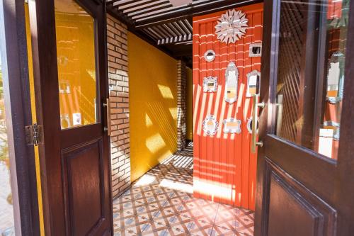 an entrance to a building with an orange door at Cabanas da Lua in Florianópolis