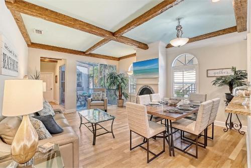 a dining room and living room with a table and chairs at Villa Castile - 5204 in Siesta Key