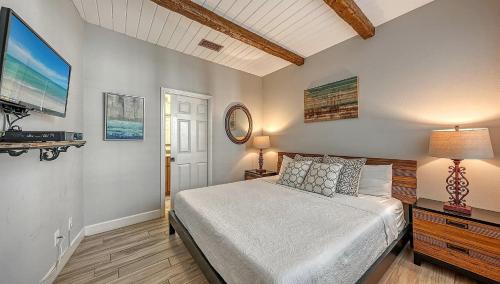 a bedroom with a bed and a television in it at Villa Castile - 5204 in Siesta Key
