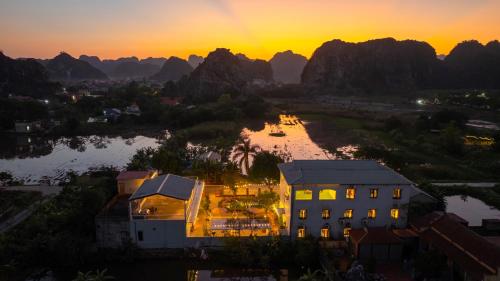 an aerial view of a building and a river at sunset at Sol Flow Retreat in Nguyên Ngoại