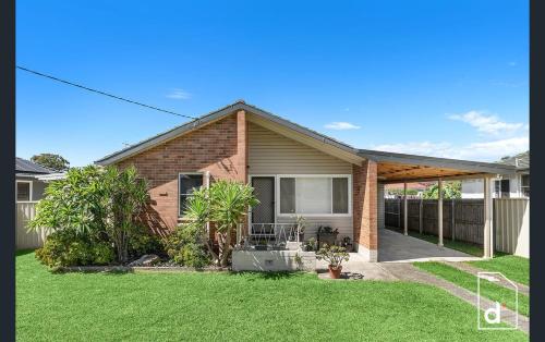 a brick house with a porch and a yard at The Illawarra Hideaway - Close to everything!