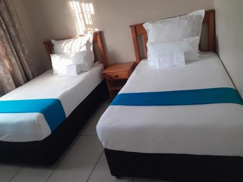 Ένα ή περισσότερα κρεβάτια σε δωμάτιο στο Mhlezi Lodge