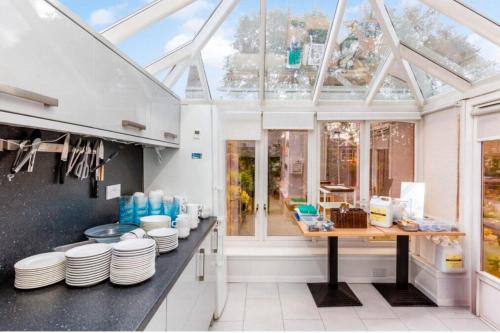 a kitchen with a glass roof with plates on a counter at West Coates Mansion in Edinburgh