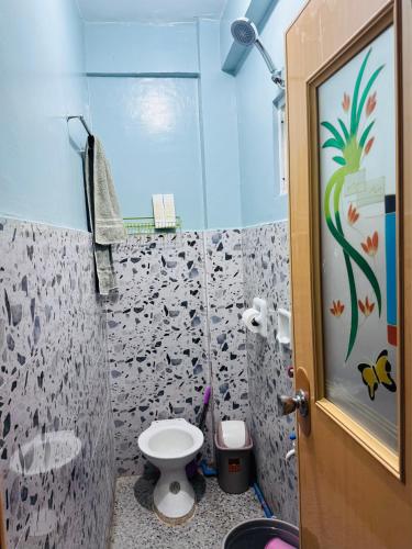 a bathroom with a toilet and a shower at Peaks&Pedals Transient in Irosin