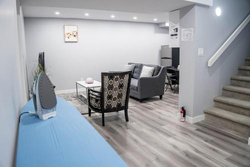 a living room with a staircase and a couch and a table at Beautiful Brand New 2BR Suite with Private Entrance and free on-site parking in Winnipeg