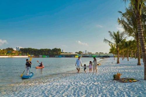a group of people standing on a beach at Luxhomes TC1 Canopy Vinhomes Smart City in Phú Thú