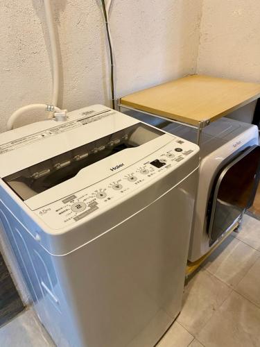 a washing machine is sitting next to a table at Ichiban an in Uji