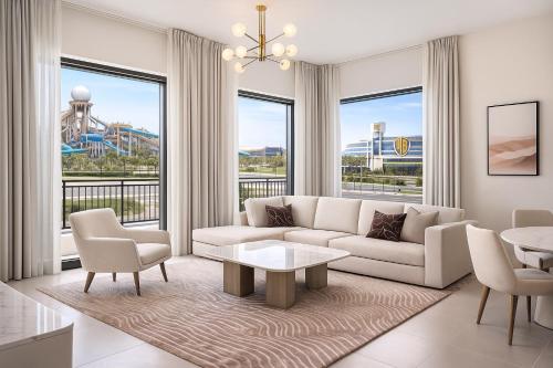 a living room with a couch and a table at Elegant 1BR Yas Island with Theme Park Views & Exclusive Yas Park Offers in Abu Dhabi