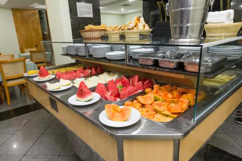 a display of different types of pastries on a counter at Hotel Columbia in São Paulo