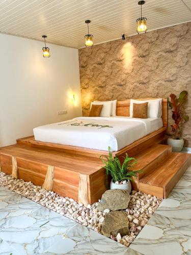 a bedroom with a bed in a room with rocks at The Bliss Ella in Ella