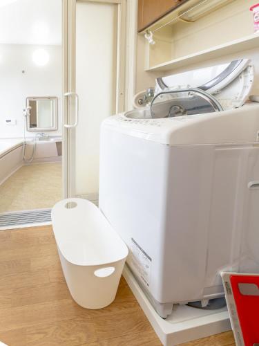 a white appliance in a room with a mirror at 鶴羽リゾート in Sanuki