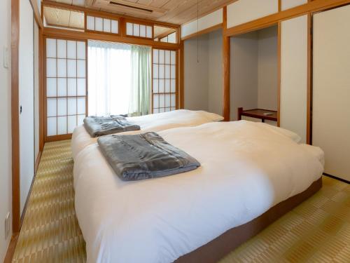 Ένα ή περισσότερα κρεβάτια σε δωμάτιο στο 鶴羽リゾート
