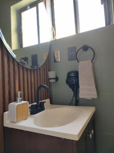 un baño con lavabo y espejo en Amber Apartment at Downtown, en Chihuahua