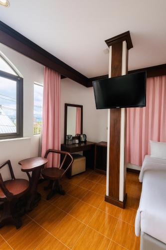 a living room with a tv and a couch at Centre Point Patong in Patong Beach