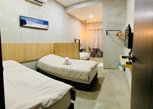 a hospital room with two beds and a tv at Leisure29 Suites in Kuantan