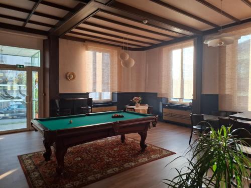 a living room with a pool table in it at Le Grand Hôtel Ussel ''nouvelle Gérance 2023'' in Ussel