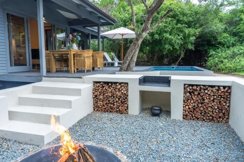 a fire pit in the backyard of a house at The Cabin Luxury Safari Villa, Private Pool, Hot tub, Outdoor Shower, Giraffe Tower, Free Standing Bath, Private Game Reserve, Romantic Getaway, Ultimate Bush Luxury in Hluhluwe