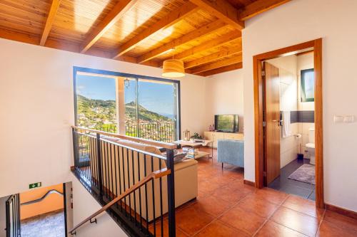 a room with a balcony with a view at Casa Miguel in Machico