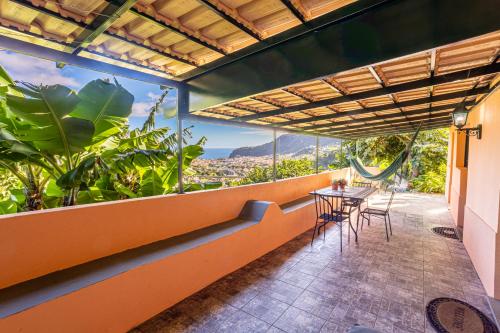 a balcony with a table and chairs and a view at Casa Miguel in Machico
