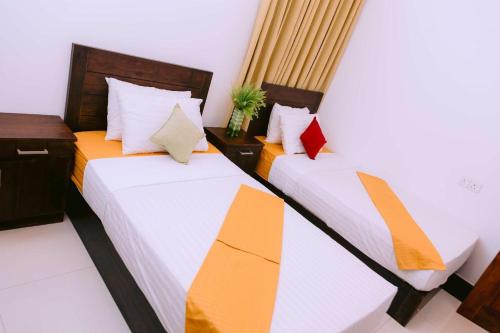 Postel nebo postele na pokoji v ubytování Yala Homestay by Set