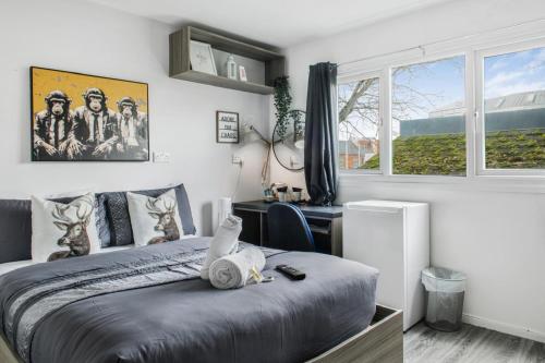 a bedroom with a bed and a desk and a window at West walk house in Nottingham