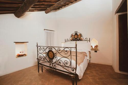 a bedroom with a metal bed in a room at Historic Villa Among Olive Groves In Arezzo in San Polo