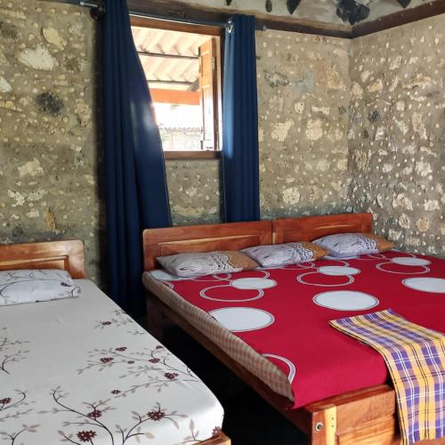 Giường trong phòng chung tại Palmyrah Resort Best Rooms with Sea View