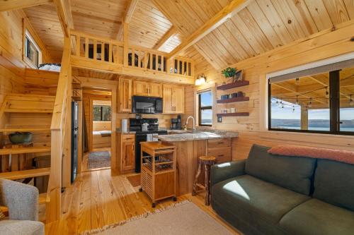 a kitchen and living room in a log cabin at P-Bay The Roost home in Reeds Spring