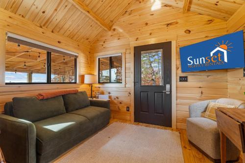 a living room with a couch and a door at P-Bay The Roost home in Reeds Spring