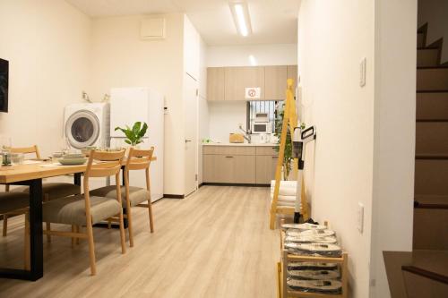a kitchen and dining room with a table and chairs at Osaka Shinsaibashi Dotonbori Courtyard Villa in Osaka